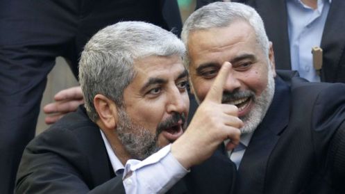 Hamas leader Khaled Meshaal (L) and Ismail Haniyeh (R) wave during a parade following Meshaal's arrival in Gaza City, on December 7, 2012
